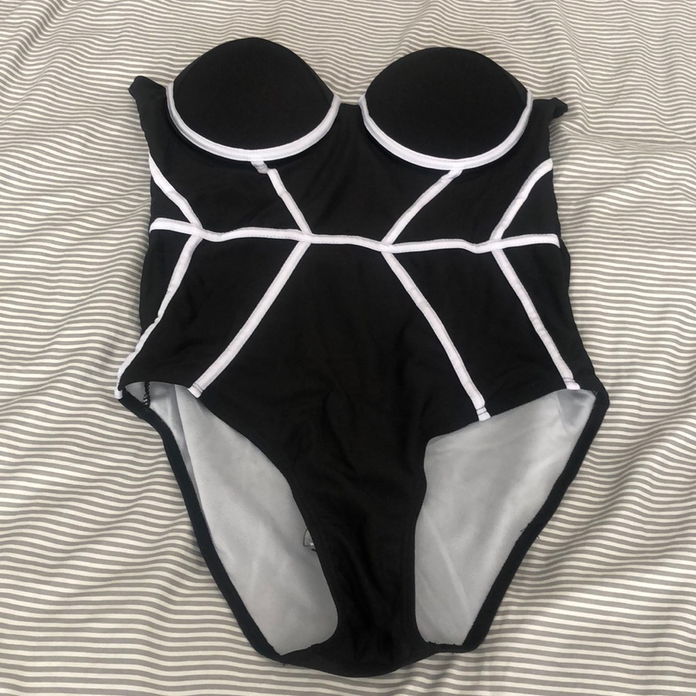 Black strapless one piece with white piping